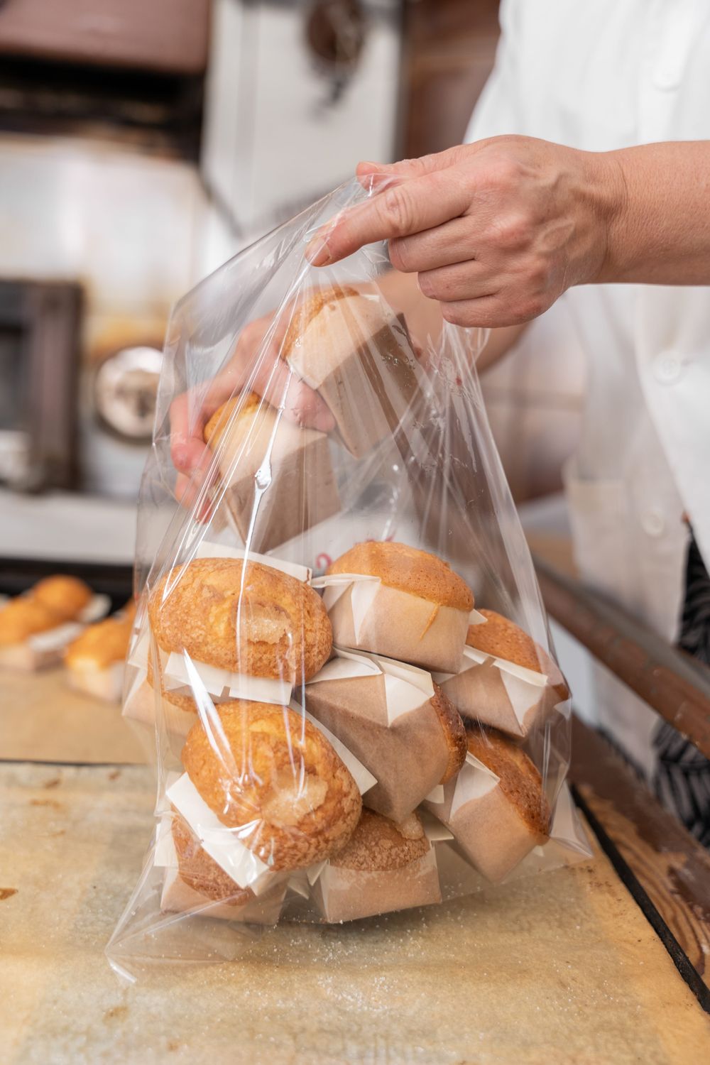 Baker packing fresh cupcakes in a clear bag
