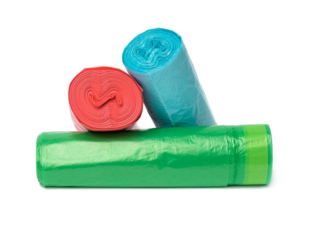 Rolls of red, blue and green trash bags
